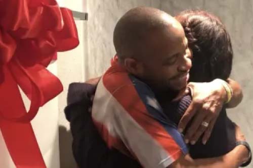 Image 40: Man hugging a child.