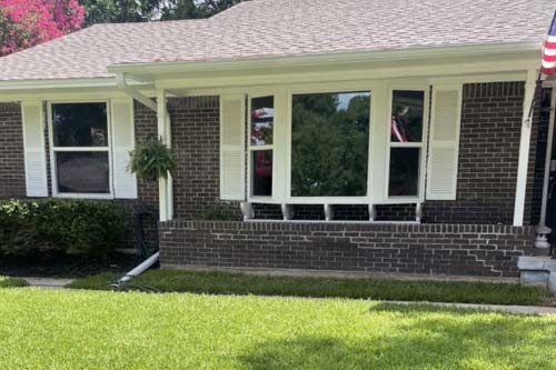 Energy efficient windows on dark brick home.